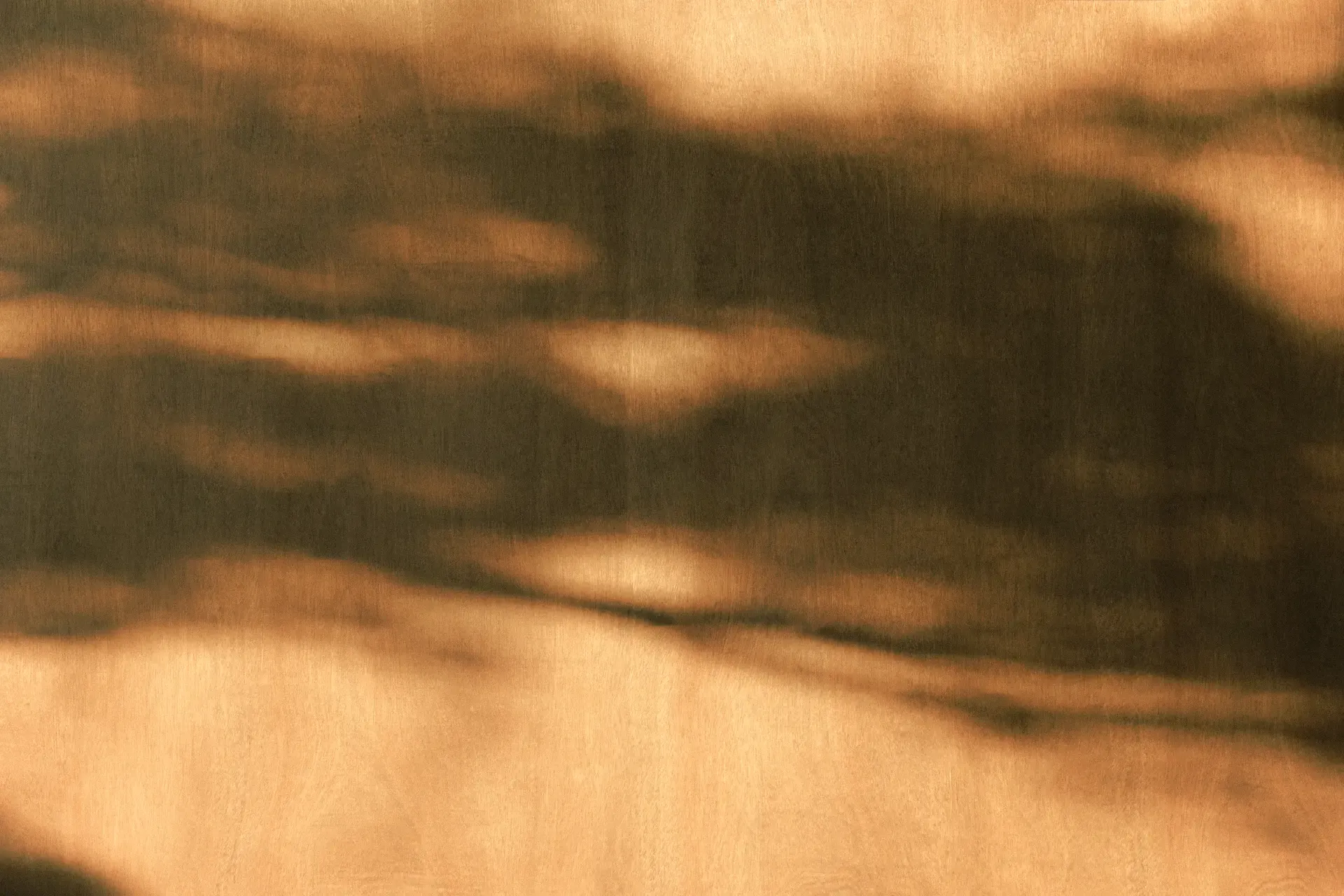 A photo of shadows against a warm background.